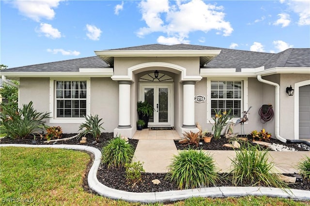 doorway to property featuring french doors and a garage