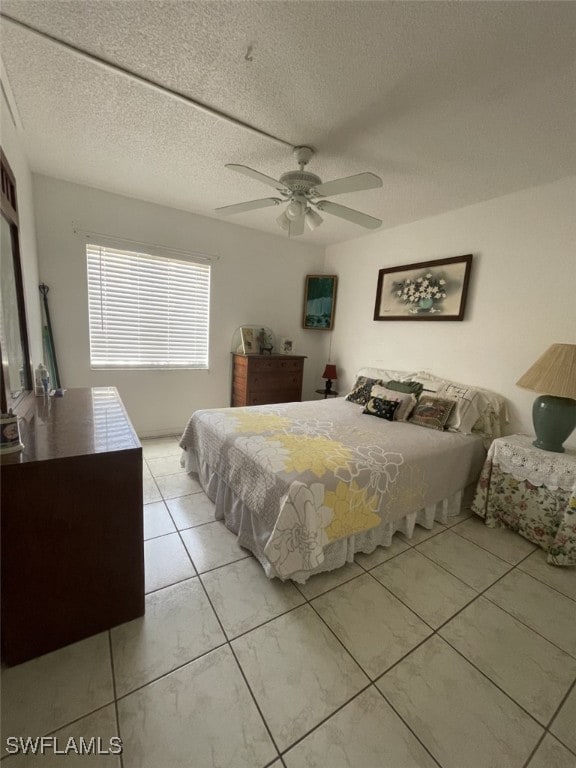 bedroom with a textured ceiling and ceiling fan