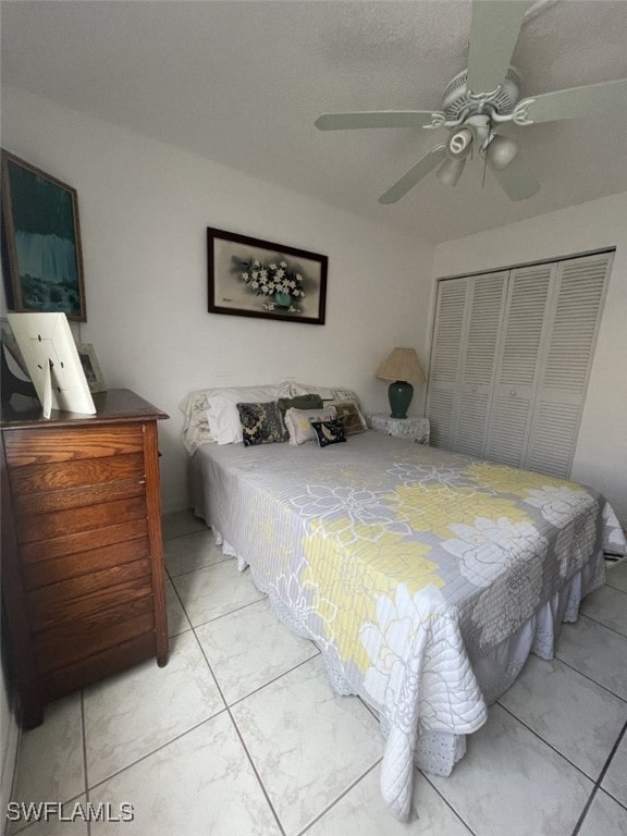 tiled bedroom featuring a closet and ceiling fan