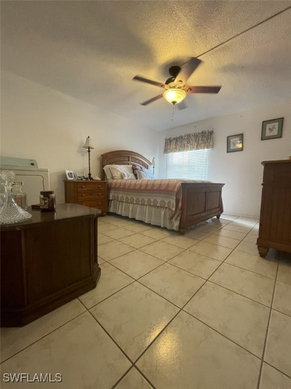 unfurnished bedroom featuring ceiling fan, a textured ceiling, and light tile patterned floors