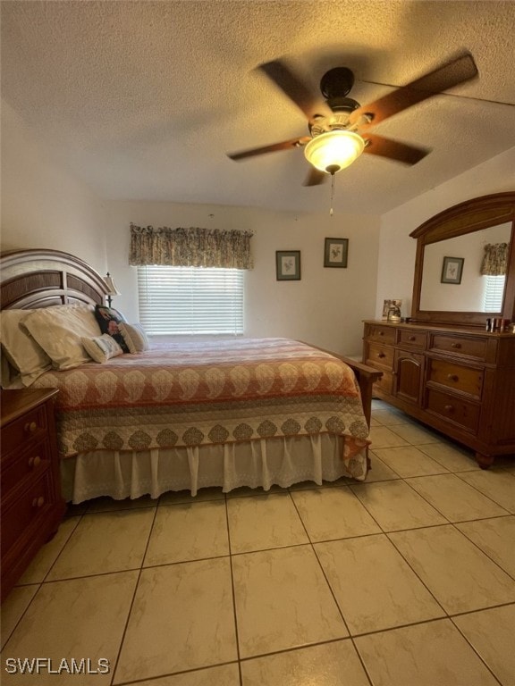 unfurnished bedroom featuring a textured ceiling, ceiling fan, and light tile patterned floors