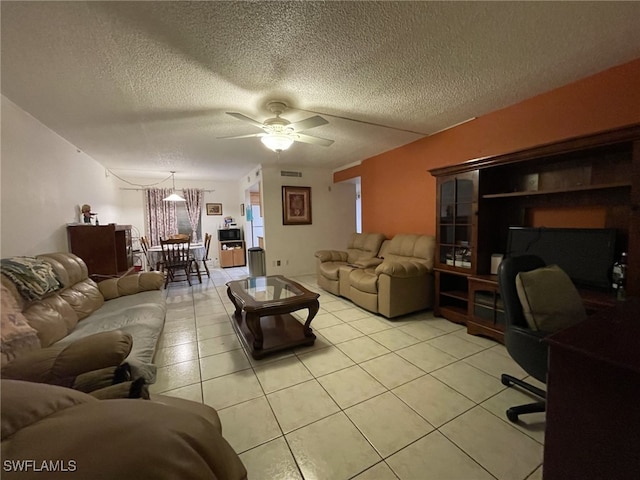 tiled living room featuring a textured ceiling and ceiling fan