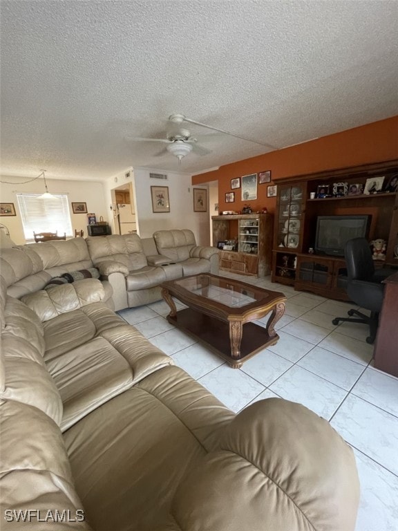 tiled living room featuring a textured ceiling and ceiling fan