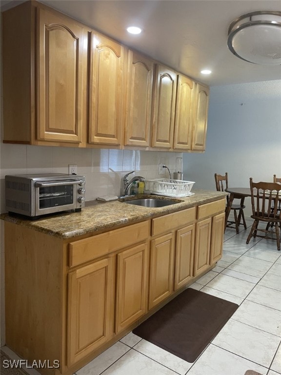 kitchen featuring sink and light tile patterned flooring