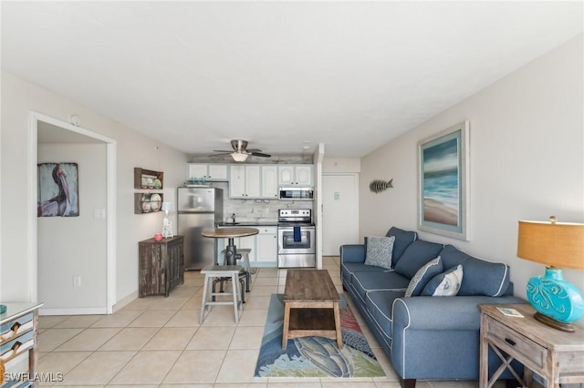 tiled living room with ceiling fan