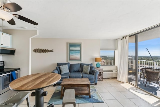 tiled living room with ceiling fan and expansive windows