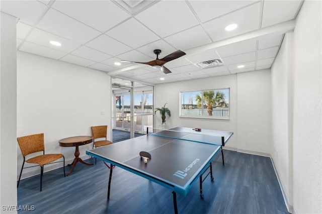 game room featuring ceiling fan, a paneled ceiling, and dark hardwood / wood-style flooring