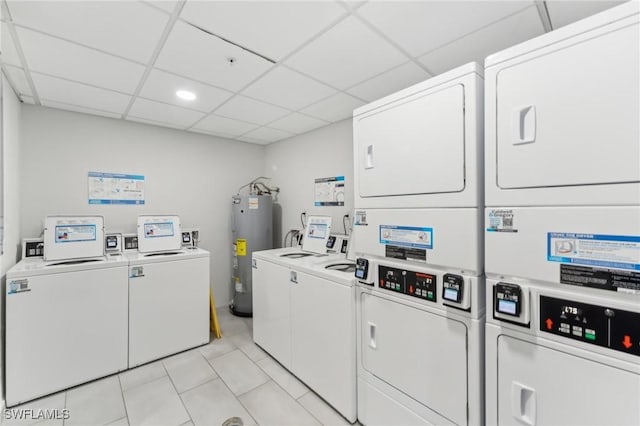 laundry room with light tile patterned floors, water heater, stacked washer and clothes dryer, and washing machine and clothes dryer