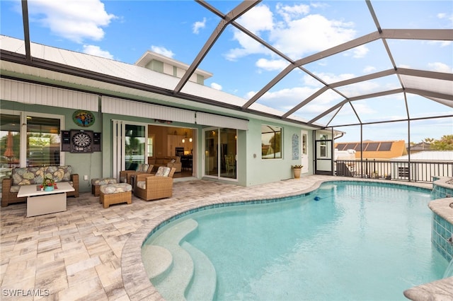 view of pool with pool water feature, a patio area, a lanai, ceiling fan, and an outdoor living space