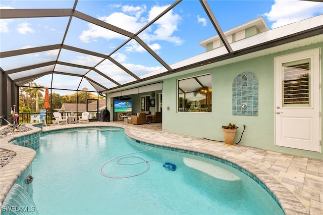 view of swimming pool featuring a patio area, outdoor lounge area, and glass enclosure