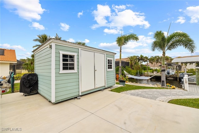 view of outbuilding with a water view