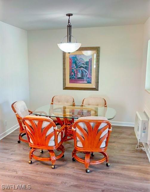 dining area with hardwood / wood-style floors