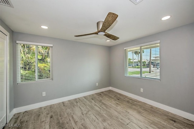 empty room featuring ceiling fan and light hardwood / wood-style flooring