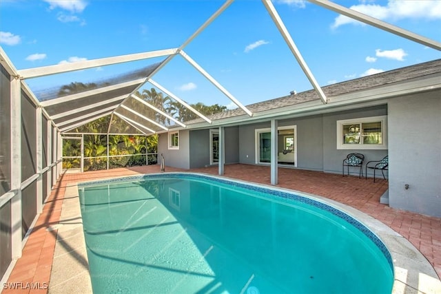 view of swimming pool featuring a lanai and a patio