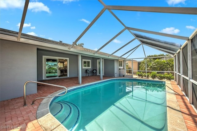 view of pool with a lanai and a patio