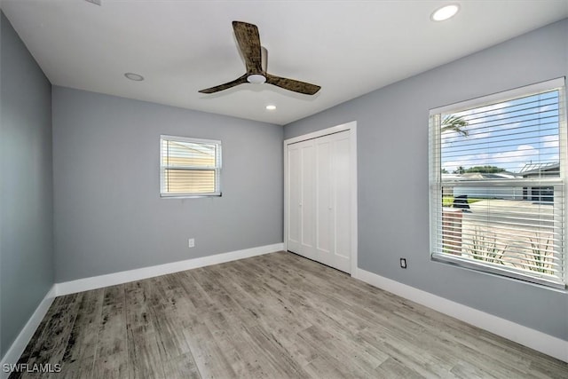 unfurnished bedroom with a closet, ceiling fan, and light hardwood / wood-style floors