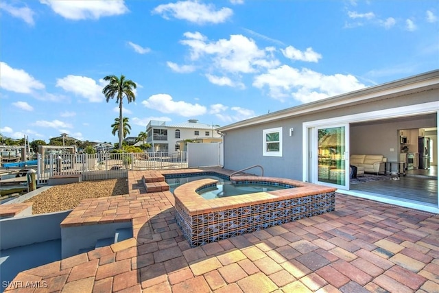 view of patio featuring an in ground hot tub