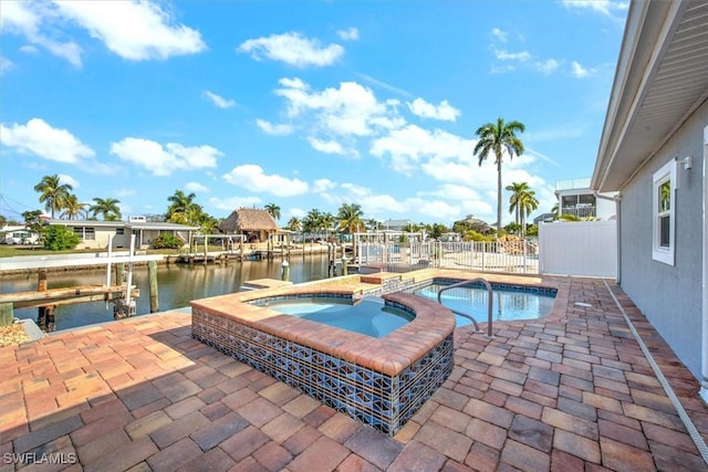 view of pool featuring a patio area, a boat dock, an in ground hot tub, and a water view