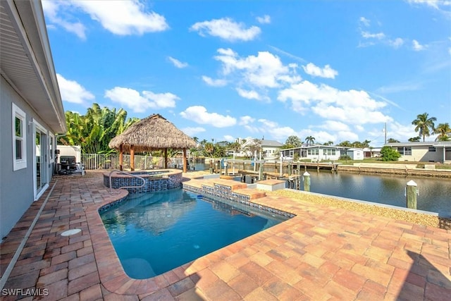 view of swimming pool with a gazebo, a patio, an in ground hot tub, and a water view