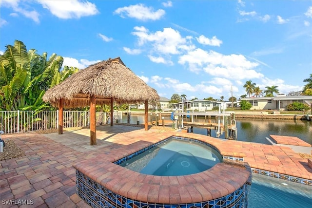 view of pool featuring an in ground hot tub, a gazebo, a boat dock, a water view, and a patio