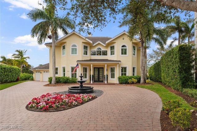 view of front of home with decorative driveway and french doors