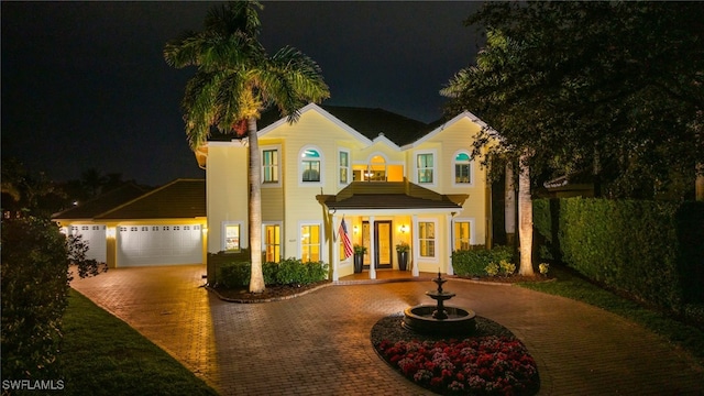 view of front facade with curved driveway and fence