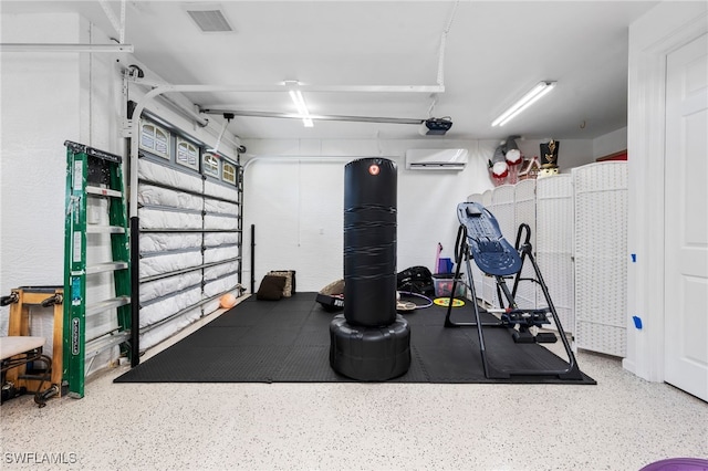 workout room featuring a garage, a wall unit AC, and visible vents