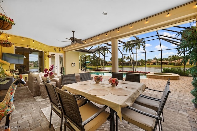 view of patio with a ceiling fan, outdoor dining space, an in ground hot tub, an outdoor pool, and an outdoor living space