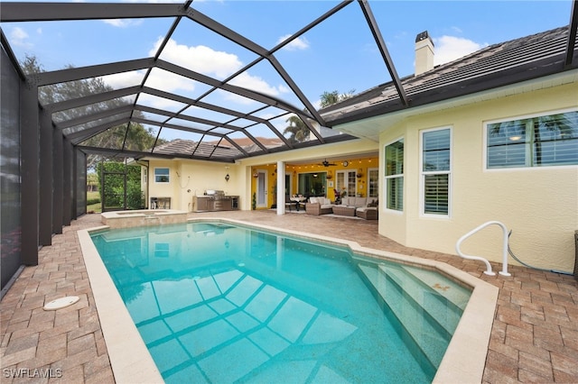 view of pool with a patio, outdoor lounge area, a lanai, and a ceiling fan