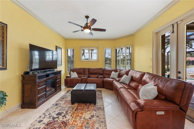 living area with ceiling fan, baseboards, crown molding, and light tile patterned flooring