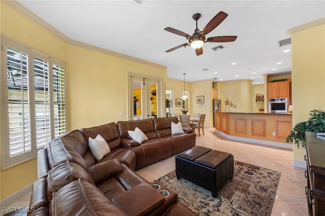 living area with plenty of natural light, visible vents, and ornamental molding