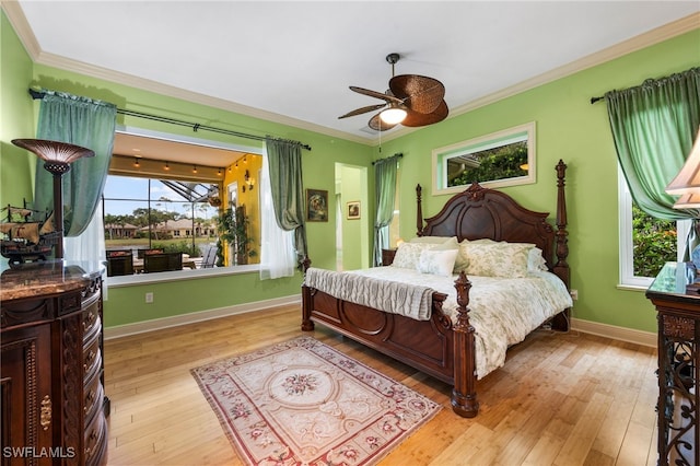 bedroom with light wood-type flooring and crown molding