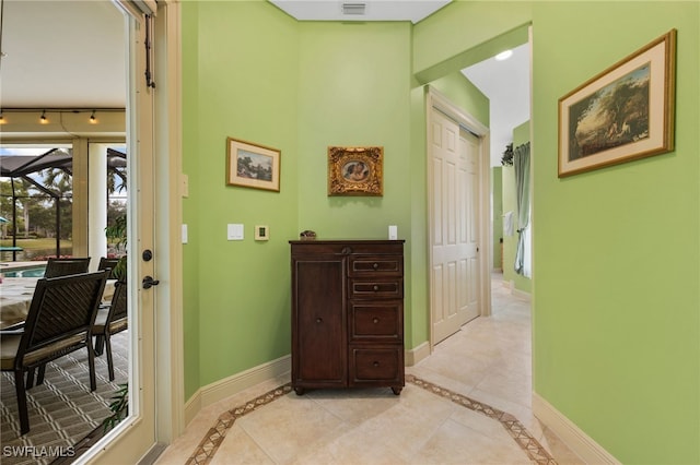 hallway with visible vents and baseboards