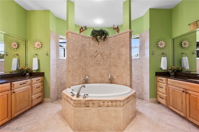 bathroom featuring tile patterned floors, plenty of natural light, and a bath