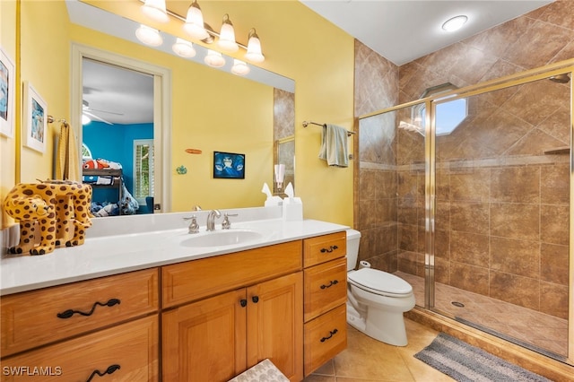 full bath with toilet, a stall shower, vanity, and tile patterned floors