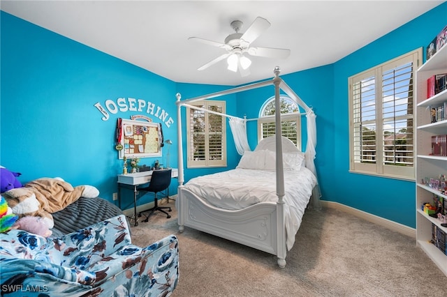 carpeted bedroom with ceiling fan and baseboards