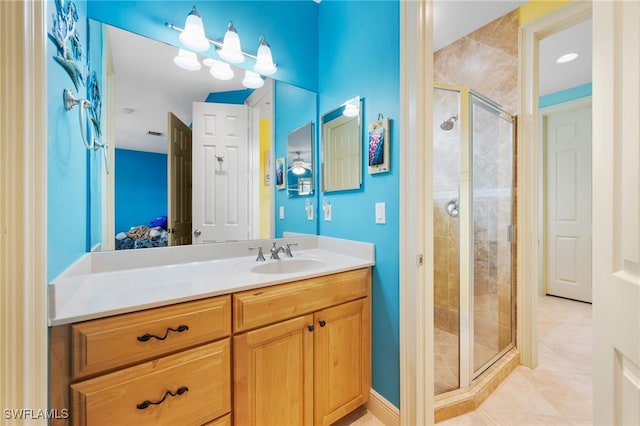 bathroom featuring a stall shower, tile patterned flooring, and vanity