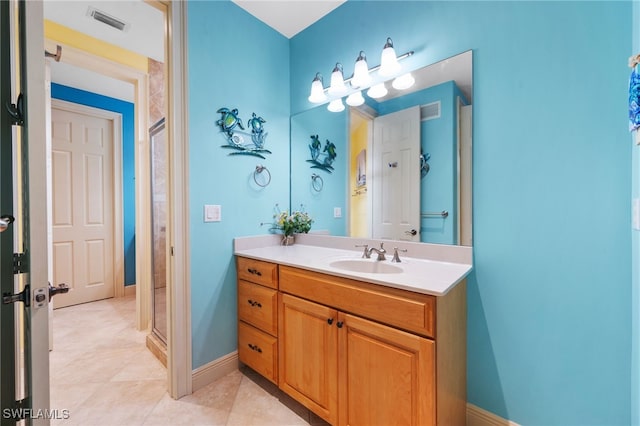 bathroom featuring baseboards, visible vents, a shower stall, and vanity