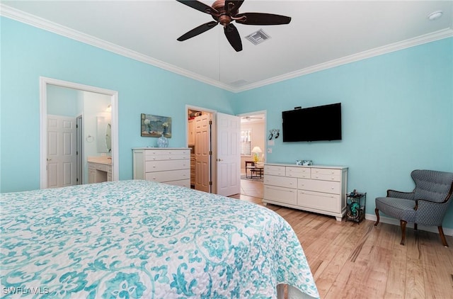 bedroom featuring light wood-type flooring, ceiling fan, crown molding, and connected bathroom