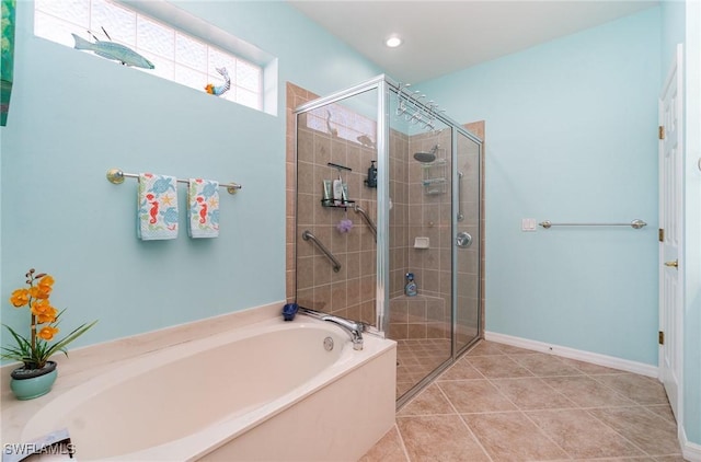 bathroom featuring tile patterned floors and separate shower and tub