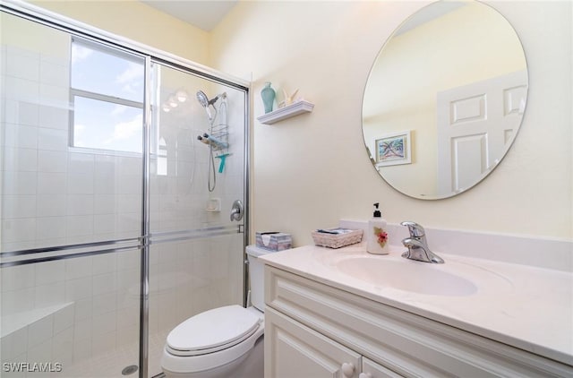 bathroom featuring walk in shower, vanity, and toilet