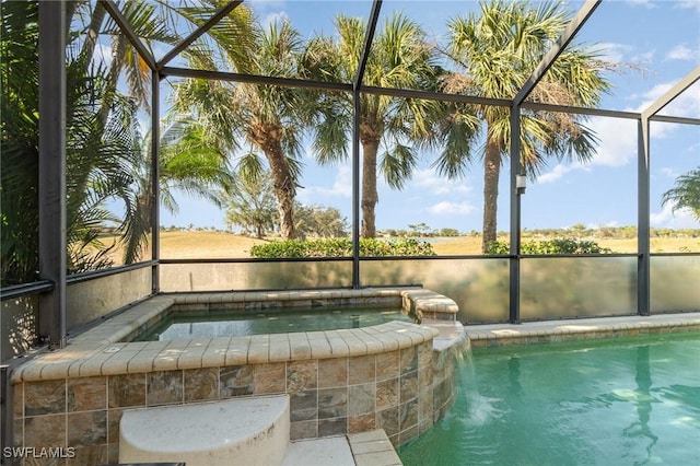 view of swimming pool featuring a lanai and an in ground hot tub