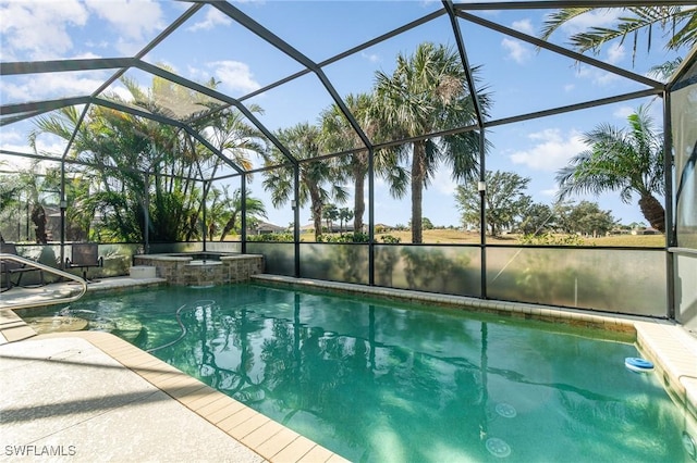 view of pool featuring a patio area, an in ground hot tub, and glass enclosure