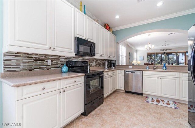 kitchen with pendant lighting, black appliances, tasteful backsplash, crown molding, and white cabinetry