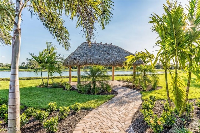 view of community with a gazebo, a yard, and a water view