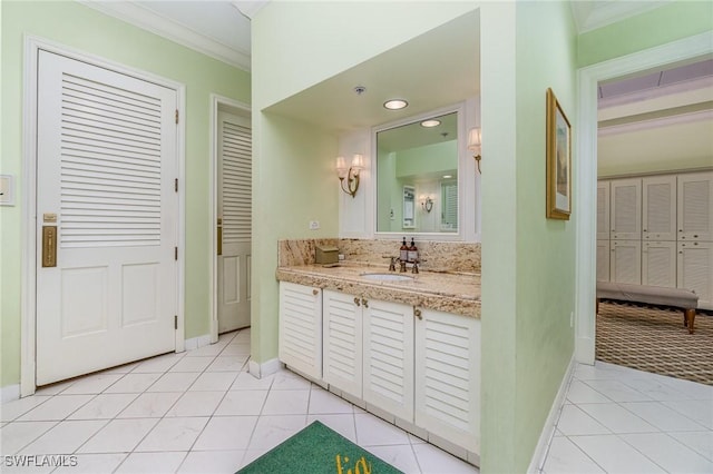 bathroom featuring ornamental molding, tile patterned floors, and vanity