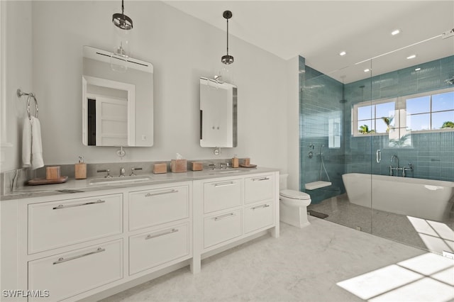 full bath featuring a shower stall, double vanity, a freestanding tub, marble finish floors, and toilet