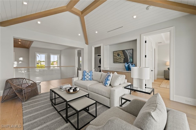 living room featuring vaulted ceiling with beams, light hardwood / wood-style flooring, and wooden ceiling