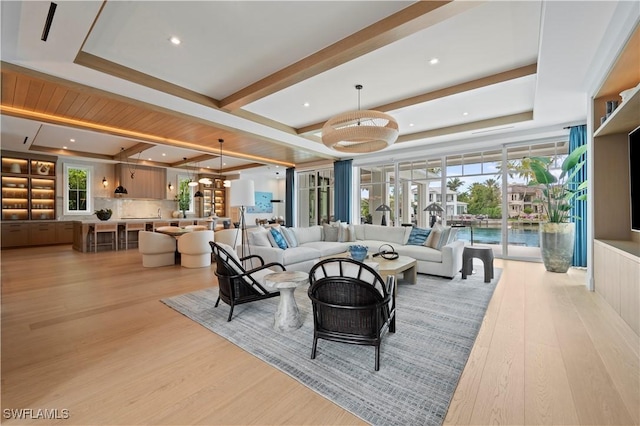 living room with light wood-type flooring, beamed ceiling, and recessed lighting