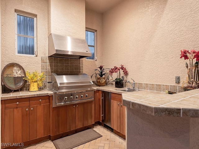 view of patio with exterior kitchen, a grill, and sink